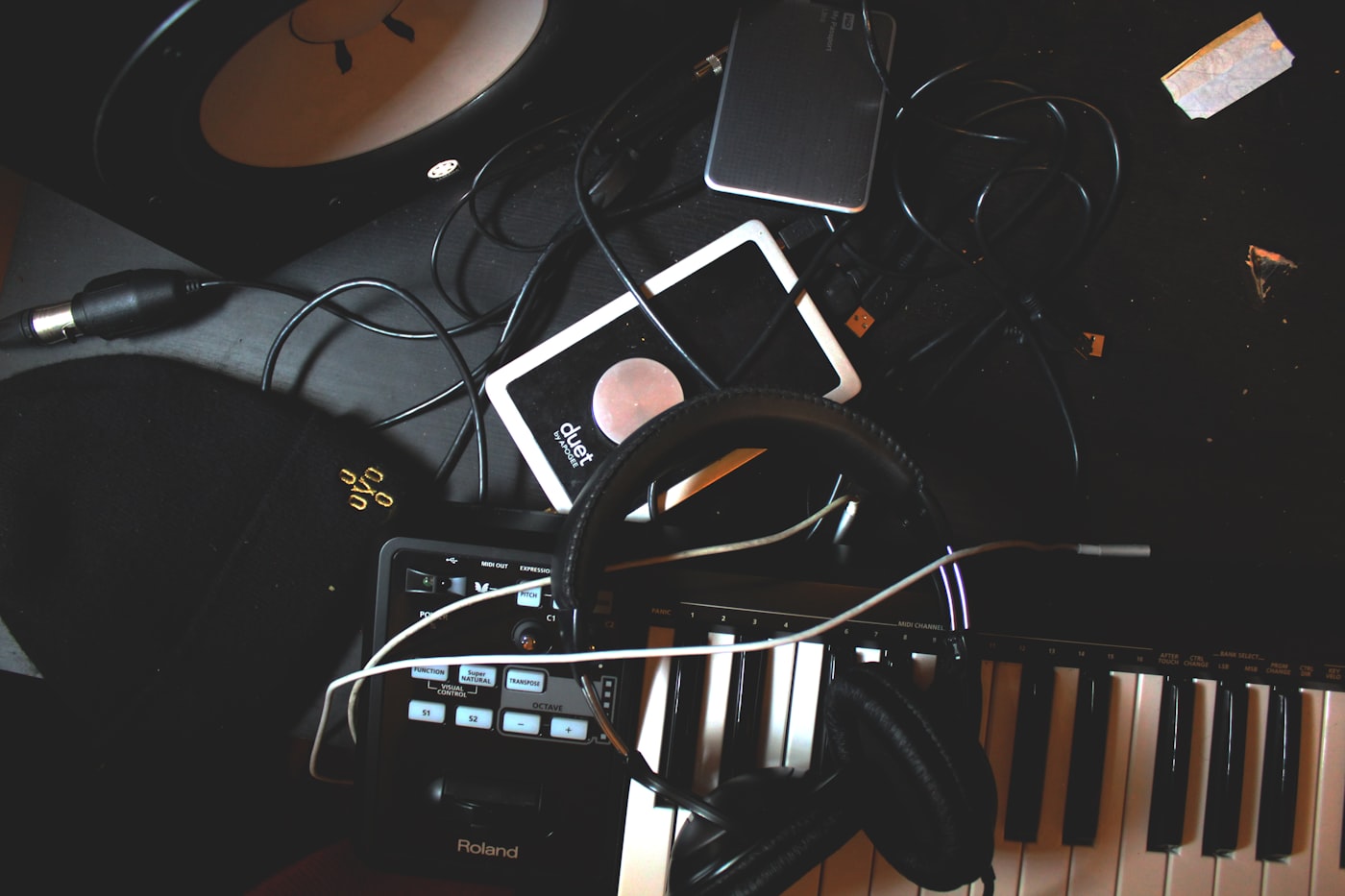 Music production gear — keyboard, headphones, and audio interface